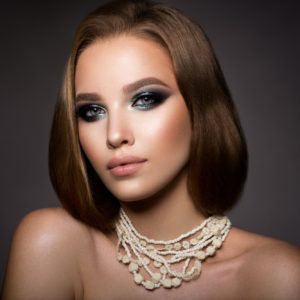 Make up. Glamour portrait of beautiful woman model with fresh makeup and romantic hairstyle.